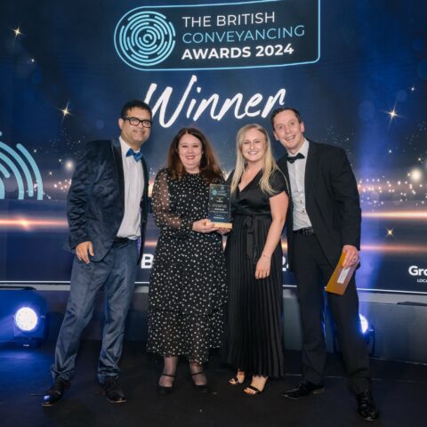 Elan Rimmer and Laura Corrigan of Oliver & Co receiving the award for Conveyancing Firm of the Year - North at the British Conveyancing Awards 2024 on 12th March 2024. Pictured with media personality Paul Sinha who hosted the awards evening, and James Shepherd, Regional Sales Manager of One Search, who sponsored the award.